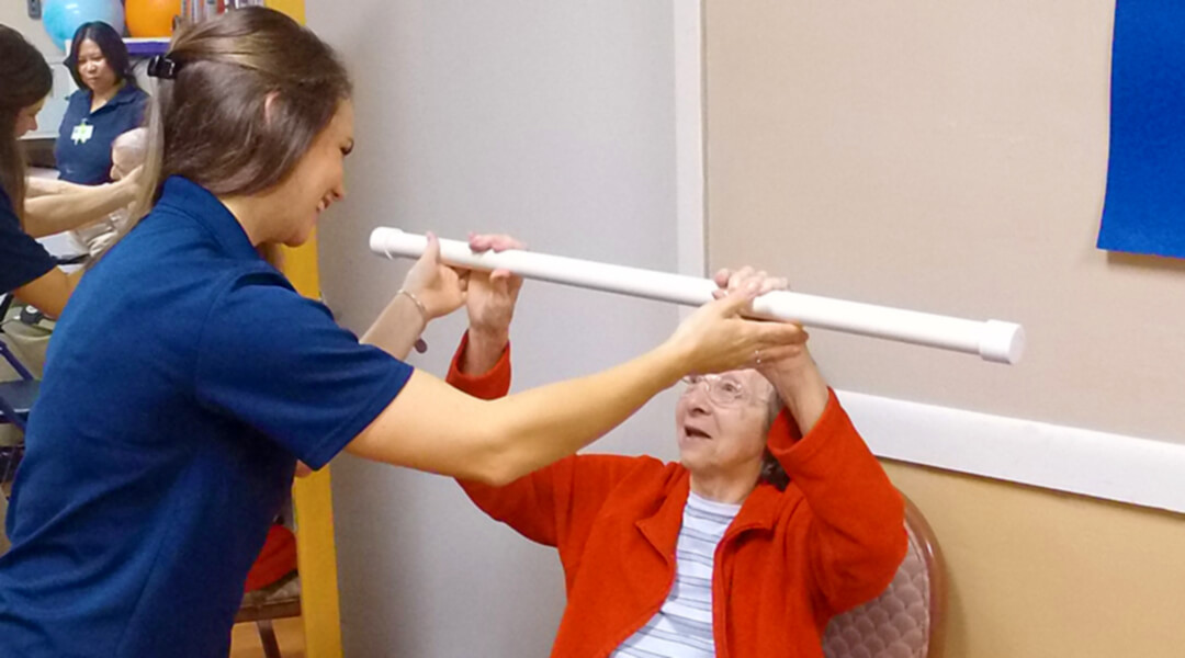 Physical Therapist with Patient Bar Raises